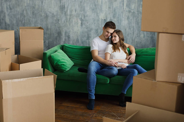 Young happy millennial couple students move into their first new owners home. Simple white background of urban apartment - Foto, immagini