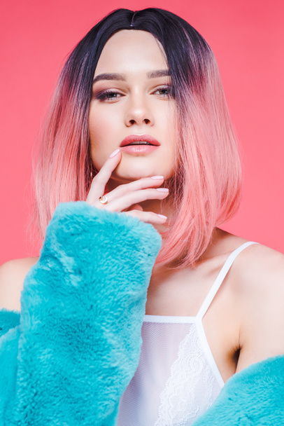 fashionable sensual girl with pink hair posing in blue fur coat, isolated on pink - Fotografie, Obrázek