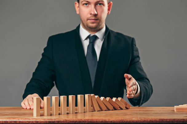 Man and wooden cubes on table. Management concept - Foto, Bild