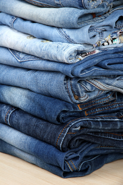 Many jeans stacked in a pile closeup - Valokuva, kuva