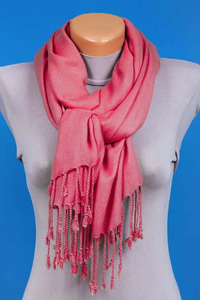 Red scarf on mannequin isolated on blue background. - Photo, Image