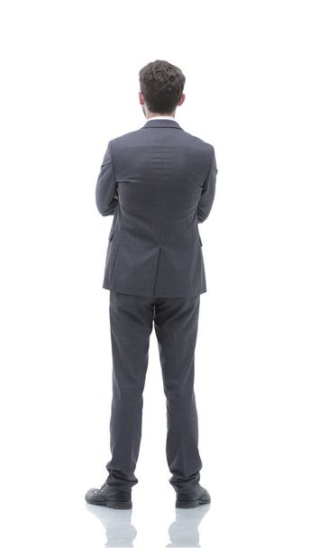 rear view, full-length of a businessman standing and looking forward. - 写真・画像