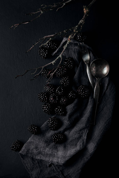 monochrome food picture of blackberries on a napkin and slate plate kitchen table can be used as background - Photo, Image