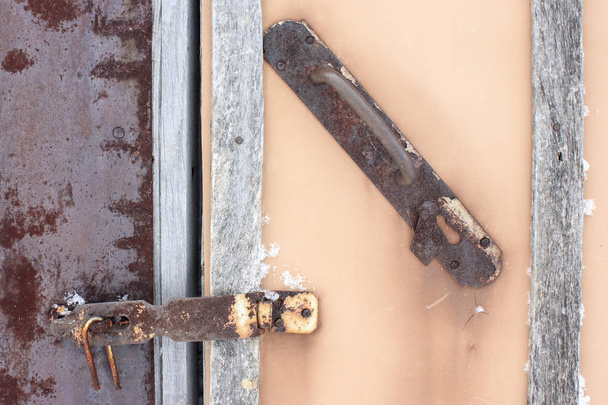 The old door is closed on the hook. Rusted Metal  - Photo, image