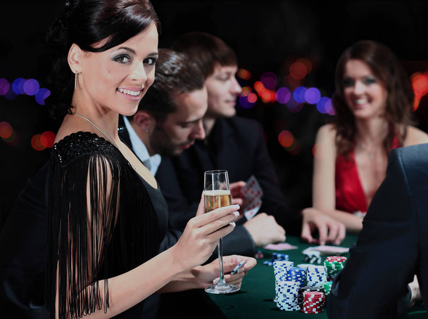 Poker players sitting around a table. - Фото, зображення