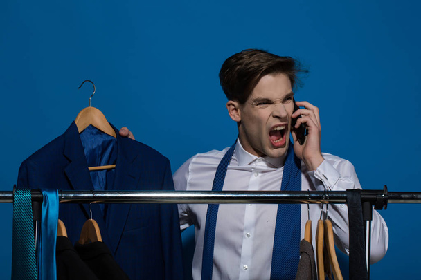 Man talk angry on smartphone with jacket in shirt, tie - Zdjęcie, obraz