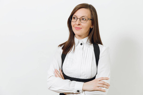 Beautiful caucasian young smiling brown-hair business woman in black suit, white shirt and glasses holding hands crossed isolated on white background. Manager or worker. Copy space for advertisement. - Valokuva, kuva