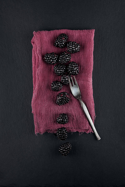 fresh ripe blackberries on a napkin and slate plate kitchen table can be used as background - Fotografie, Obrázek