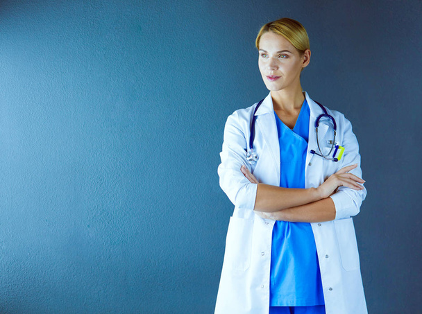 Portrait of young woman doctor with white coat standing in hospital. - Foto, Imagem