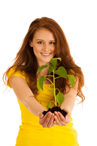 attractive Beautiful young woman holds seedling isolated over wh - Foto, Bild