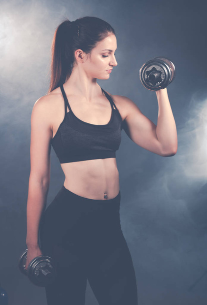 Active young sporty hispanic woman workout with dumbbells isolat - Fotografie, Obrázek