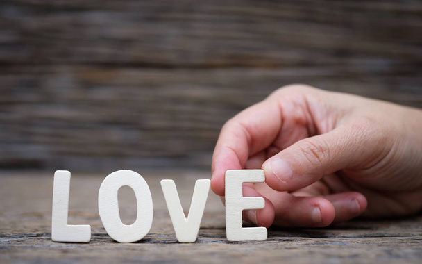 Wooden letters word "LOVE" on woman's hand. - Foto, Imagen