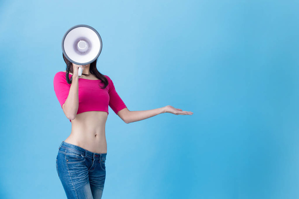 woman with megaphone  on the blue background - Foto, Bild
