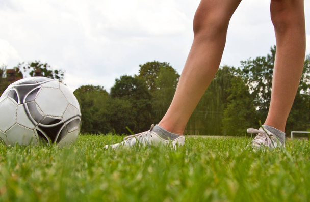 legs of soccer or football player at stadium - Foto, Bild
