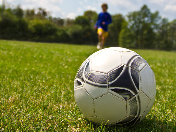 futball játékos rúgja a labdát a láb - Fotó, kép