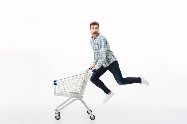 Full length portrait of a cheerful man jumping - Foto, afbeelding