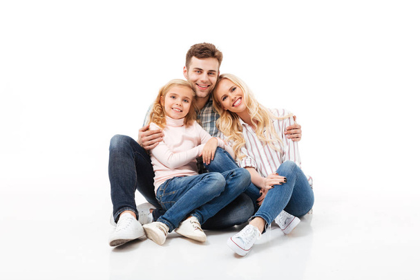 Portrait of a happy family sitting together and hugging - Φωτογραφία, εικόνα