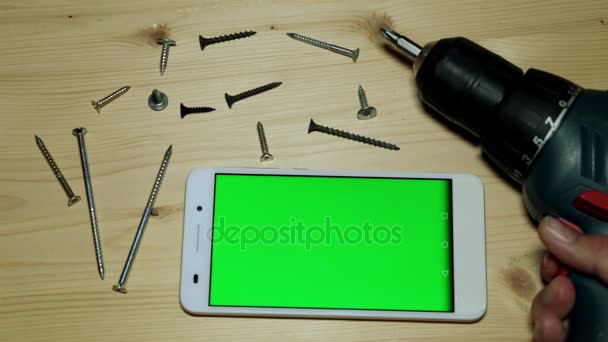 Building tools and a smartphone with a green screen. - Footage, Video