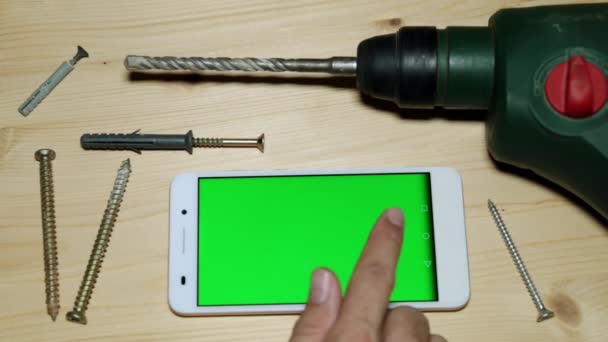 Κατασκευή puncher και smartphone με μια πράσινη οθόνη. - Πλάνα, βίντεο
