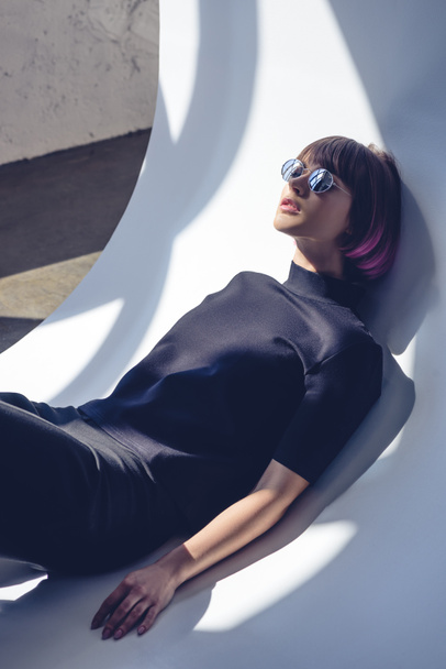 stylish girl lying in black clothes and sunglasses  - Zdjęcie, obraz