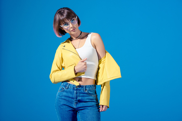 girl in fashionable clothes posing isolated on blue - Photo, Image