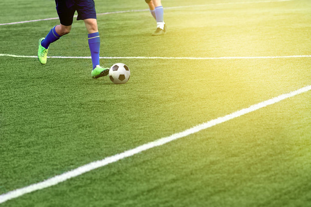 Closeup of a soccer ball and soccer player at the stadium. - Valokuva, kuva