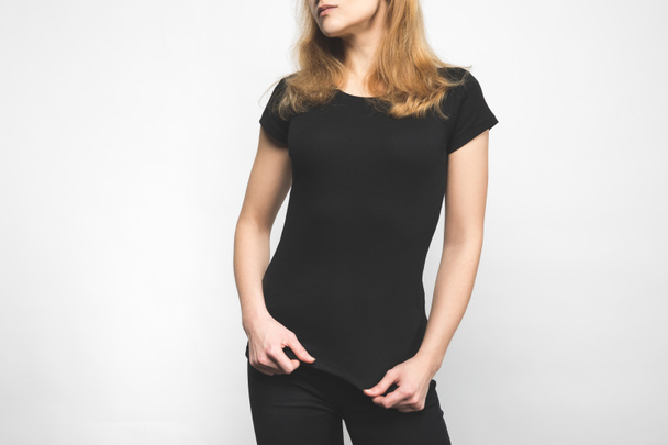 cropped shot of young woman in blank black t-shirt on white - Photo, Image