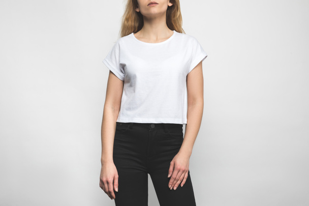 cropped shot of young woman in blank t-shirt on white - Photo, Image
