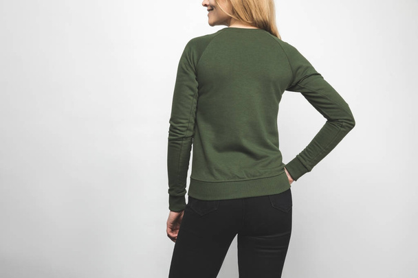 rear view of young woman in blank green sweatshirt on white - Photo, Image