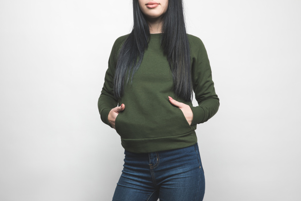 young woman in blank green sweatshirt on white - Photo, Image