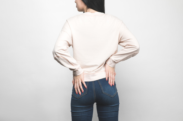rear view of young woman in blank sweatshirt on white - 写真・画像