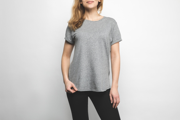 cropped shot of attractive young woman in blank grey t-shirt isolated on white - Photo, Image