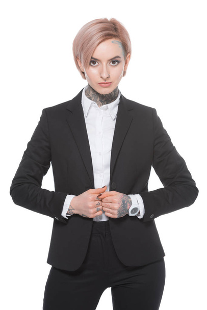 tattooed businesswoman with pink hair posing in suit, isolated on white - Foto, imagen