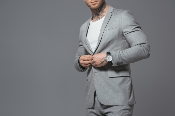 cropped view of stylish businessman in grey suit, isolated on grey - Фото, зображення