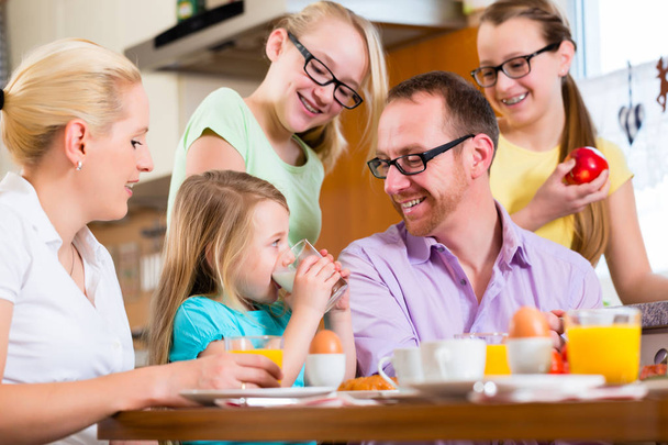Family at home having breakfast in kitchen - Photo, image
