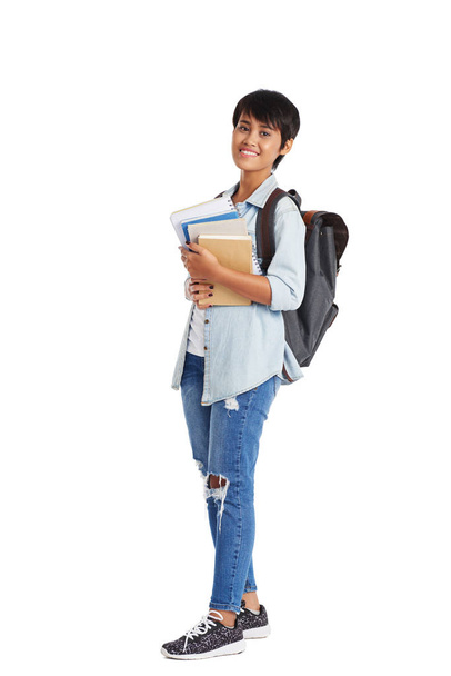 Full length portrait of cheerful university student with textbooks in hands, isolated on white background - Photo, image