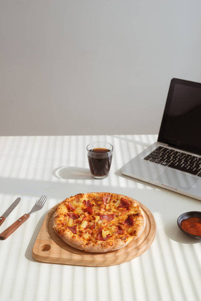 Lekkere pizza op Bureau met cokes en laptop, fastfood - Foto, afbeelding
