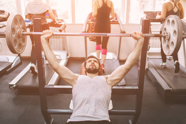 Muscular Bearded man during workout in the gym. - Φωτογραφία, εικόνα