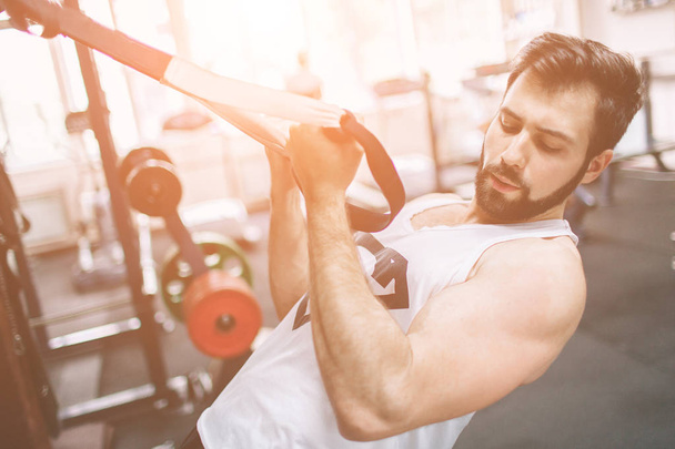 Muscular Bearded man during workout in the gym. - Photo, Image