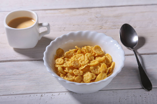 Corn Flakes cereal in a bowl and cap with espresso coffee. Morning breakfast. - Фото, зображення