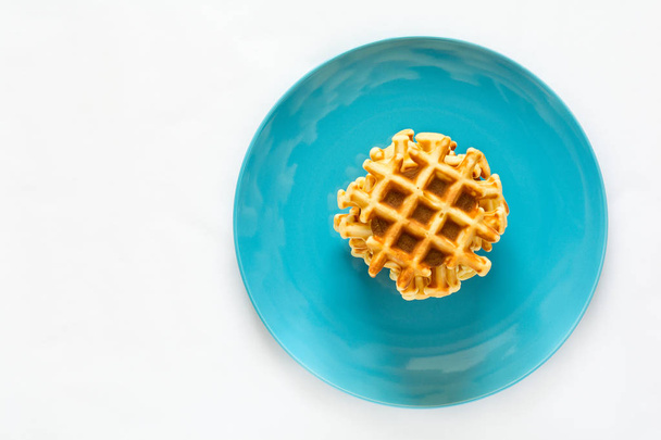 Homemade Belgian waffles on blue plate. Selective focus - Foto, imagen