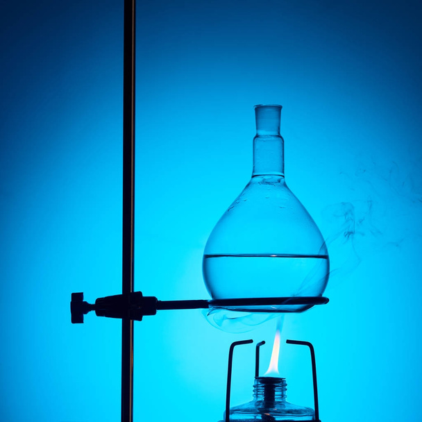 warming up liquid for chemical test isolated on blue - Foto, afbeelding