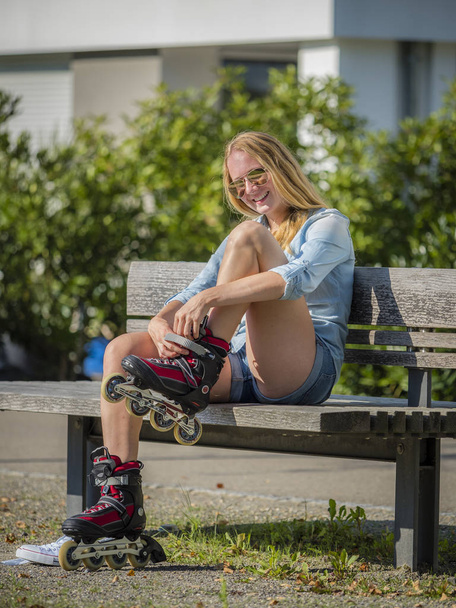 jonge vrouw, 20 jaar oud met inline rolschaatsen in een stedelijk gebied - Foto, afbeelding