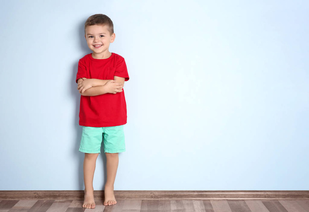 Cute little boy standing near color wall - Photo, Image