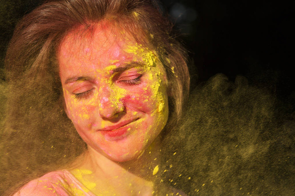Closeup portrait of wonderful brunette girl with Holi paint blow - Valokuva, kuva