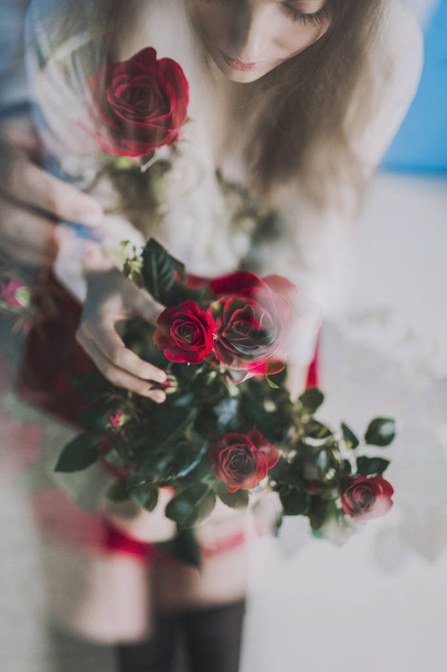 close-up of pretty girl with roses in red skirt indoor - Photo, Image