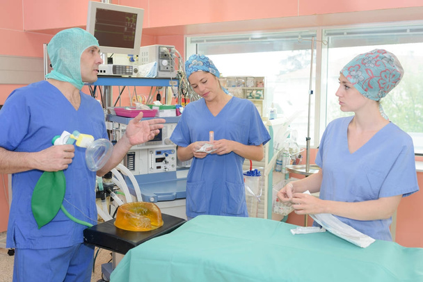 surgeons standing in operation room at the hospital - Photo, Image