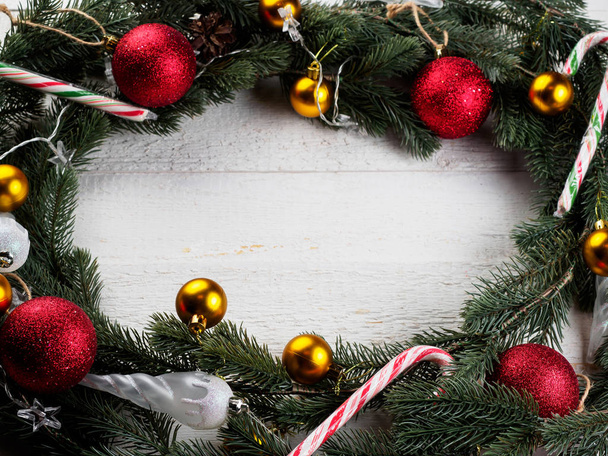 Christmas spruce branch wreath on the wood board - 写真・画像