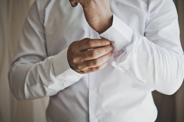 Young man buttons and a buttoned shirt sleeve 6808. - Fotó, kép