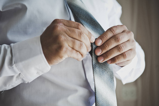 A young man wears a tie 6809. - Фото, изображение